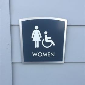 An ADA sign indicates a women's restroom